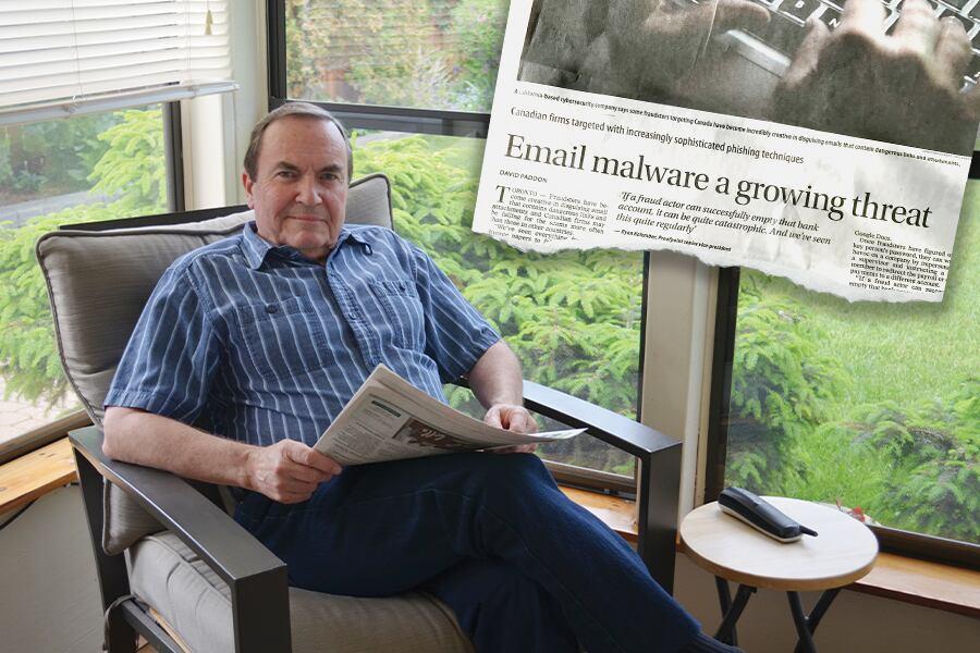 A man sitting in a chair reading a newspaper.