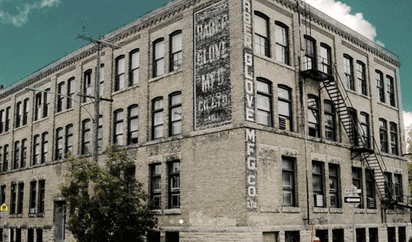 An old brick building with a sign on it.
