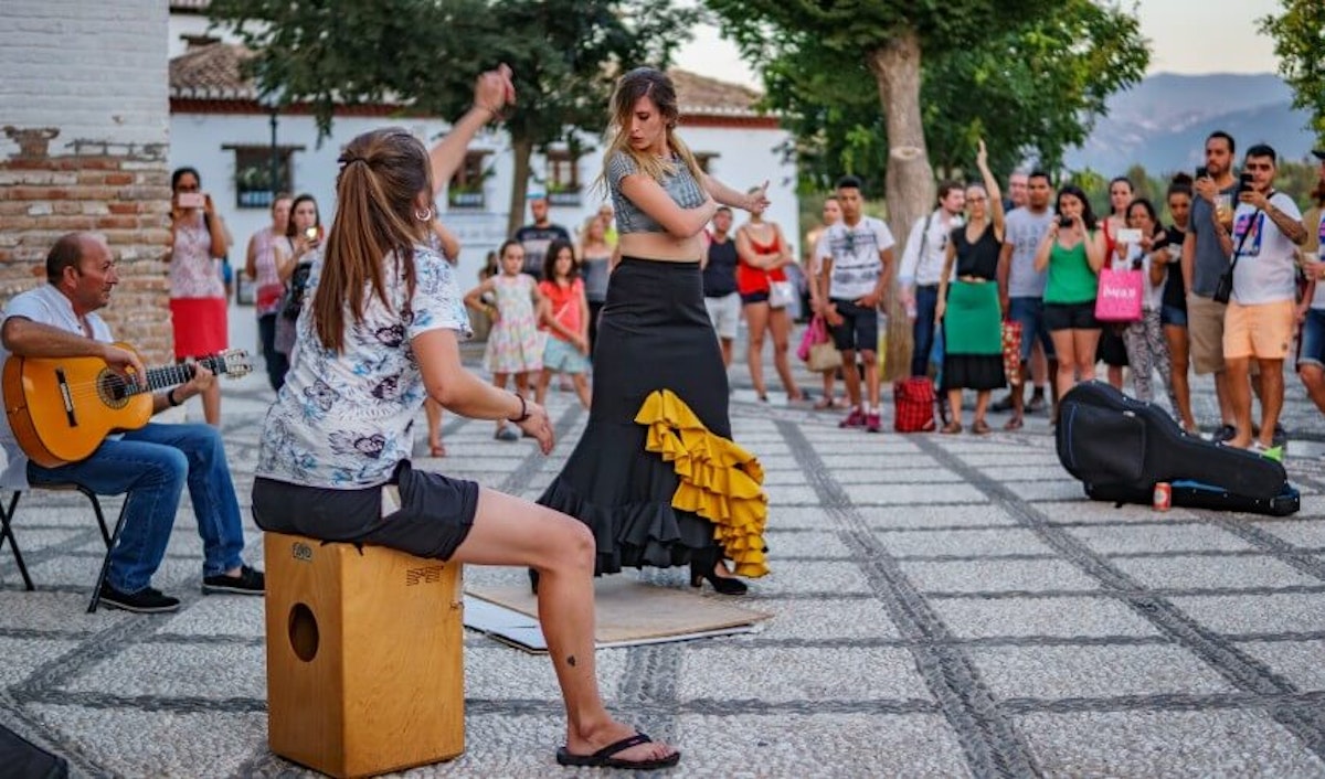 A group of people watching a flamenco performance.