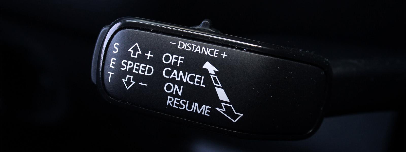 A black paddle shifter with various setting options printed on it in white.