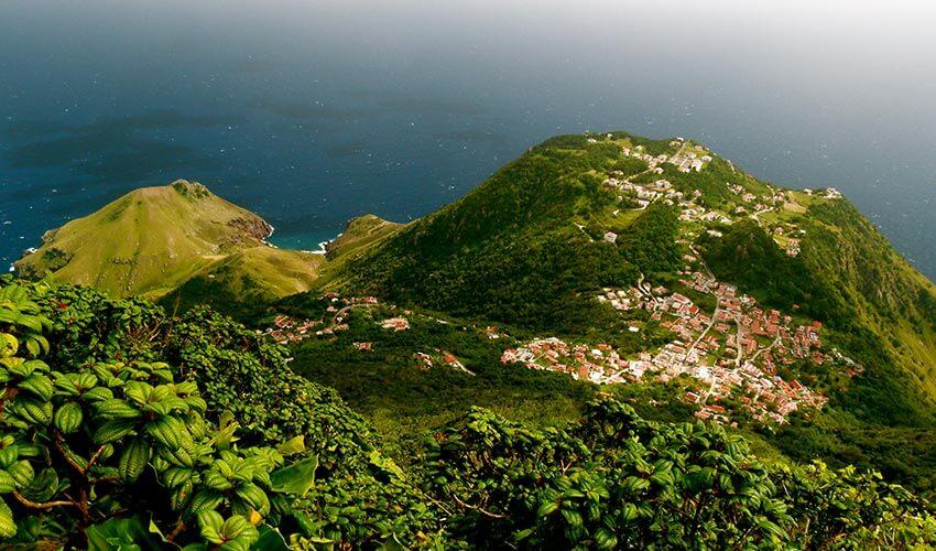 A small town on a mountain overlooking the ocean.