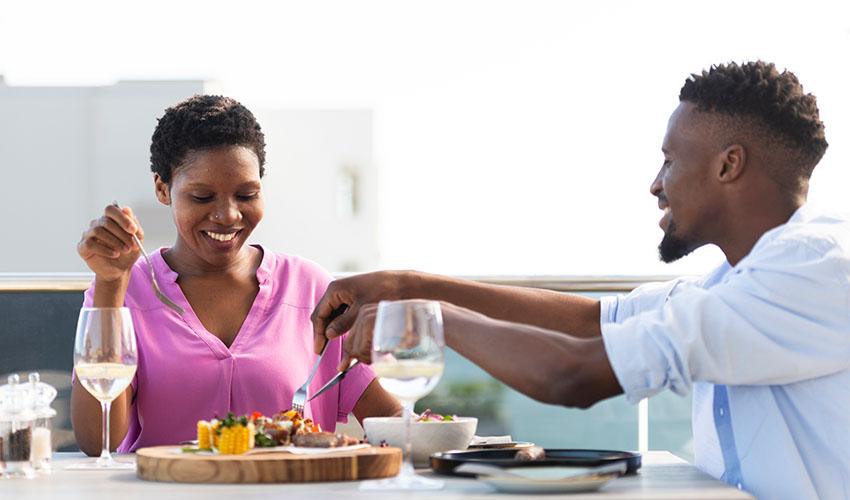 A couple at a dining table on a cruise ship.