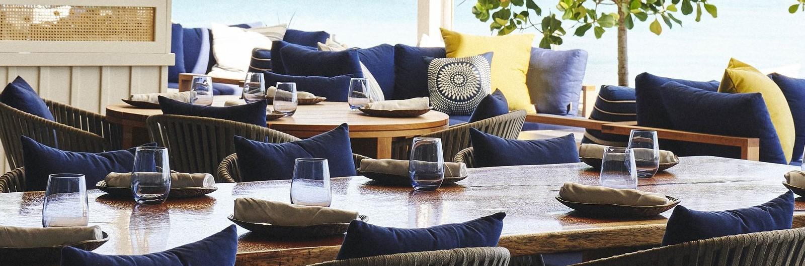 Dining table setting with blue pillows