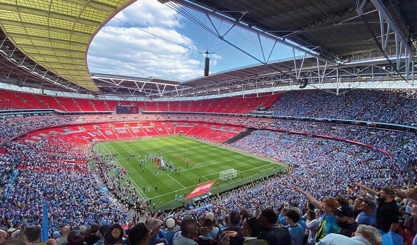 Stadium filled with spectators during a daytime sports event.