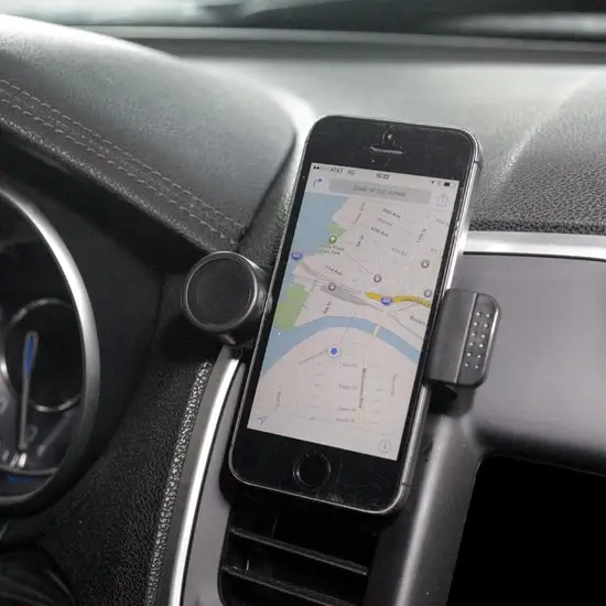 A phone holder in a car with a map on it.