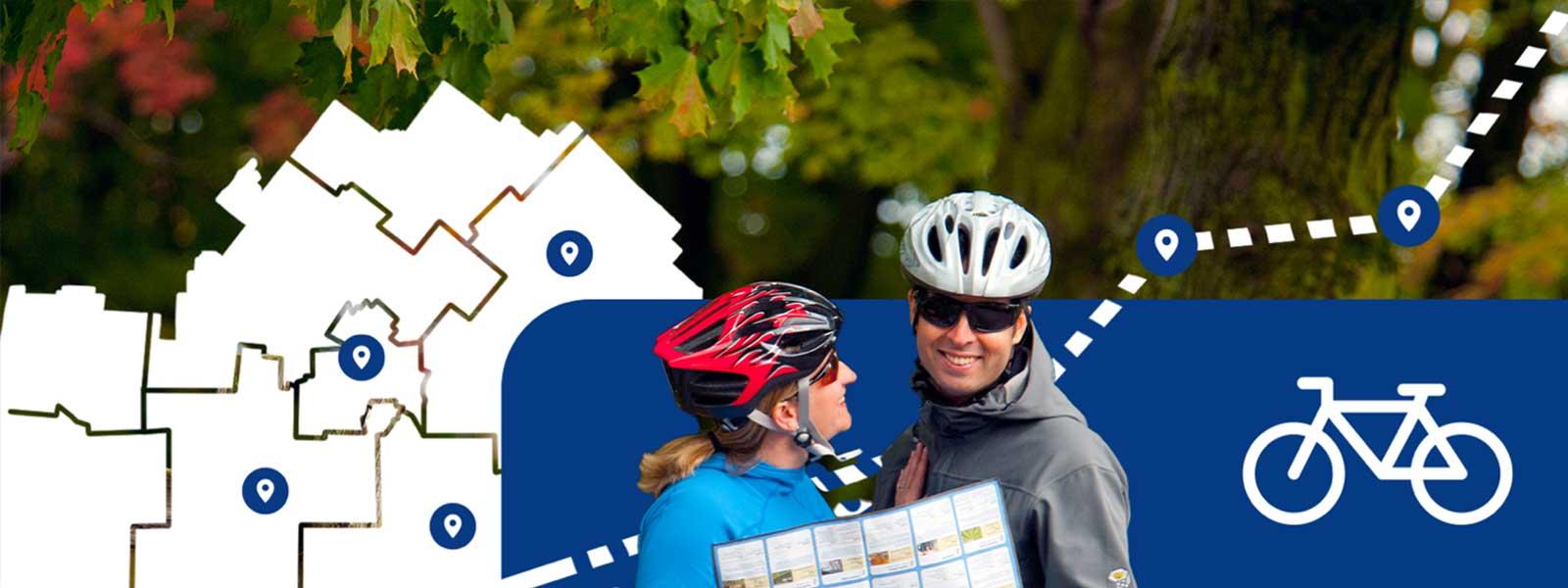 Two people wearing activewear jackets and bike helmets look at a map while smiling. In the background are illustrated elements such as a black and white map with blue pins on it, and a white bike icon.