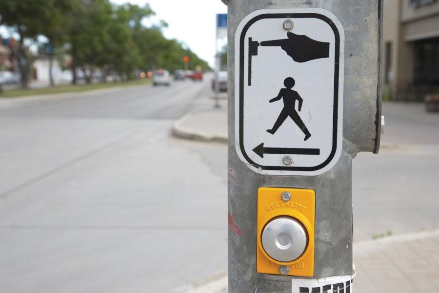 A pedestrian crossing sign on a pole.